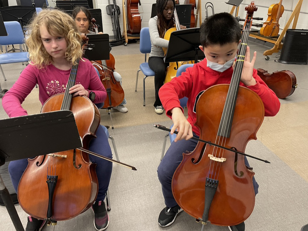 2 children playing cello