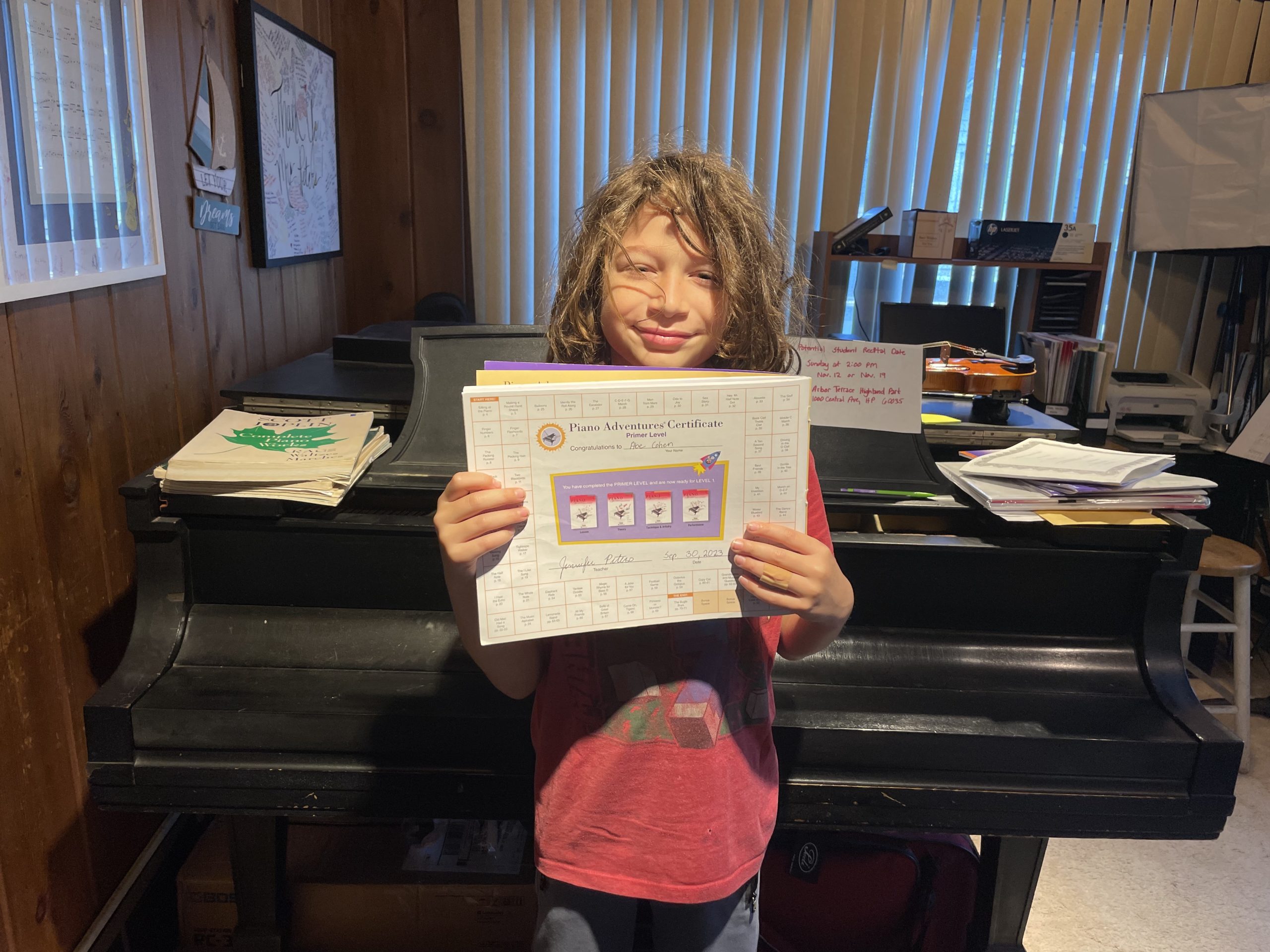 Boy holding piano book