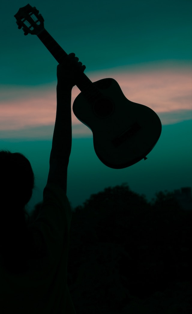 Holding a ukulele in the air